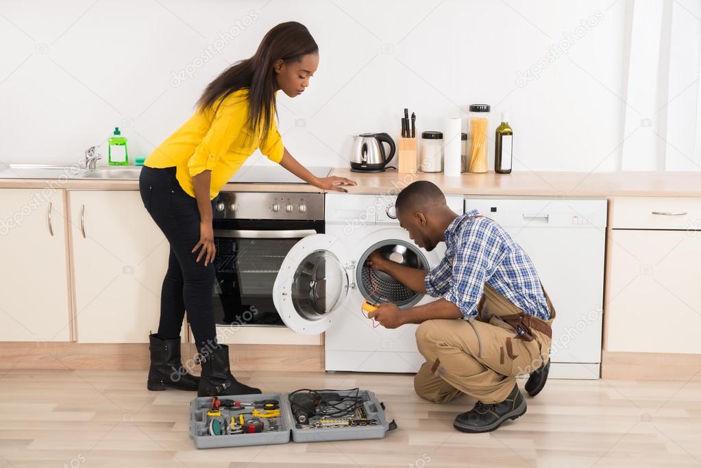 Technician fixing a washing machine