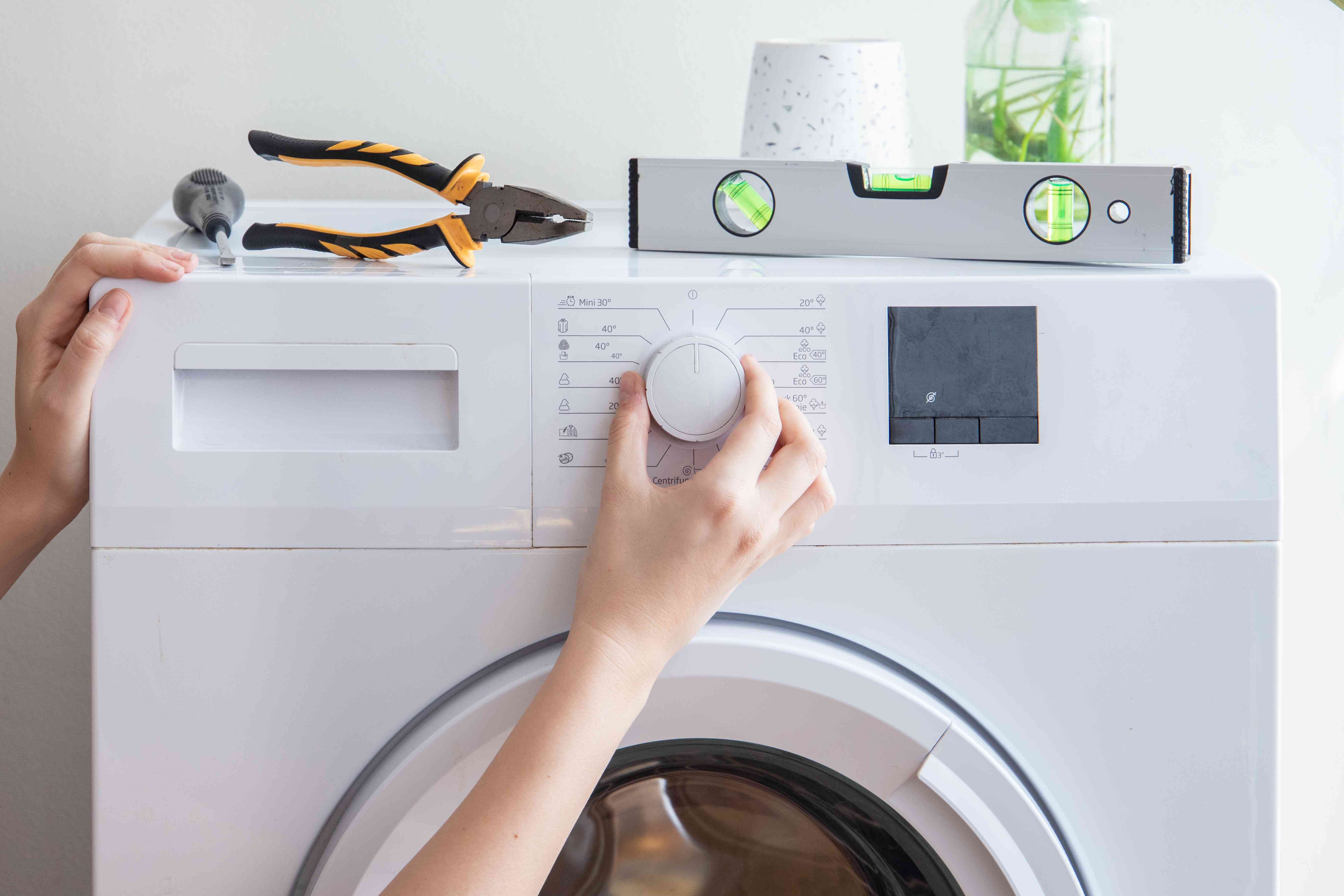 Srinivas Enterprises technician repairing a washing machine